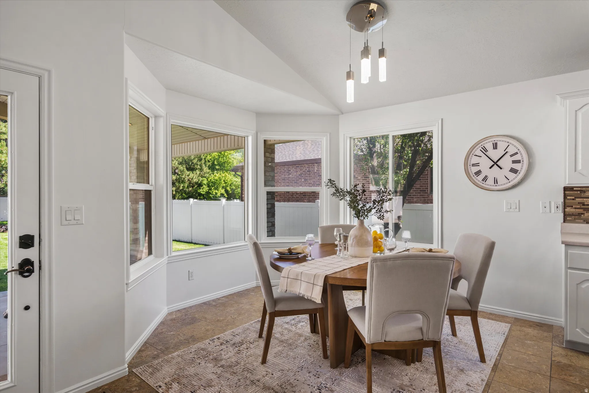 Dining area featuring a contemporary chandelier and bay windows