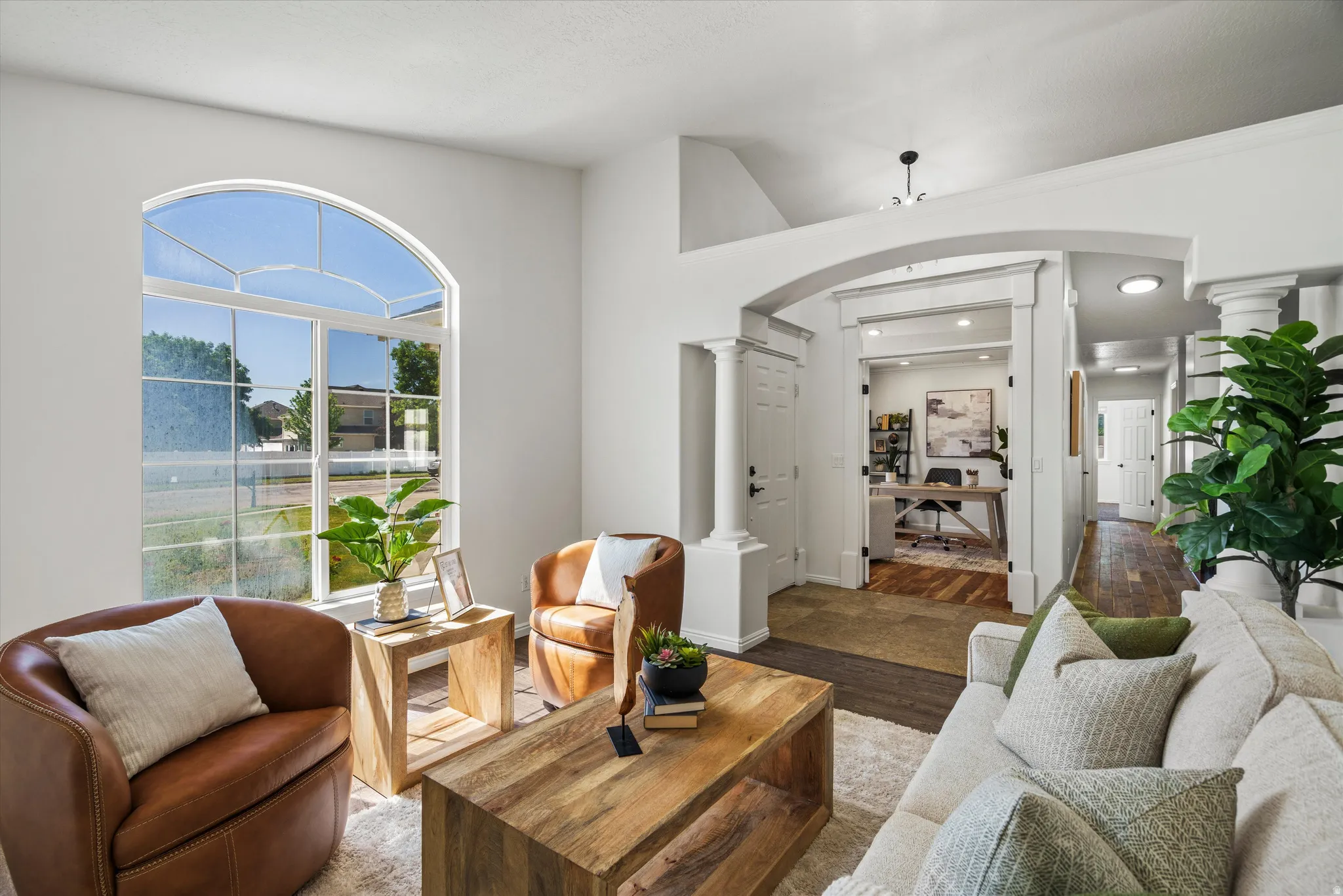 Vaulted ceilings complement the grand arched window, illuminating the space