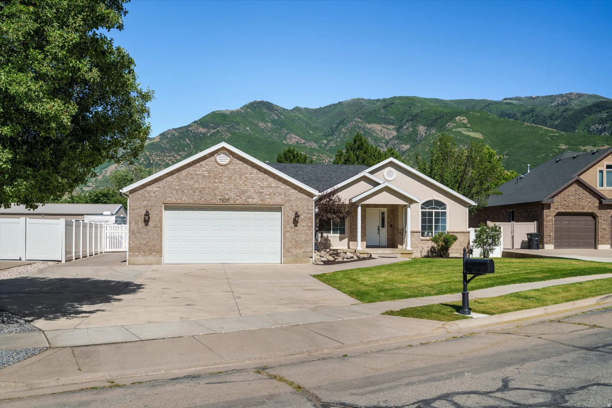 Parking. Ranch-style residence featuring a brick and stucco exterior, two-car garage, and a covered front entry