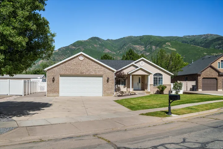 Brick Rambler two car garage with RV Drive to shop
