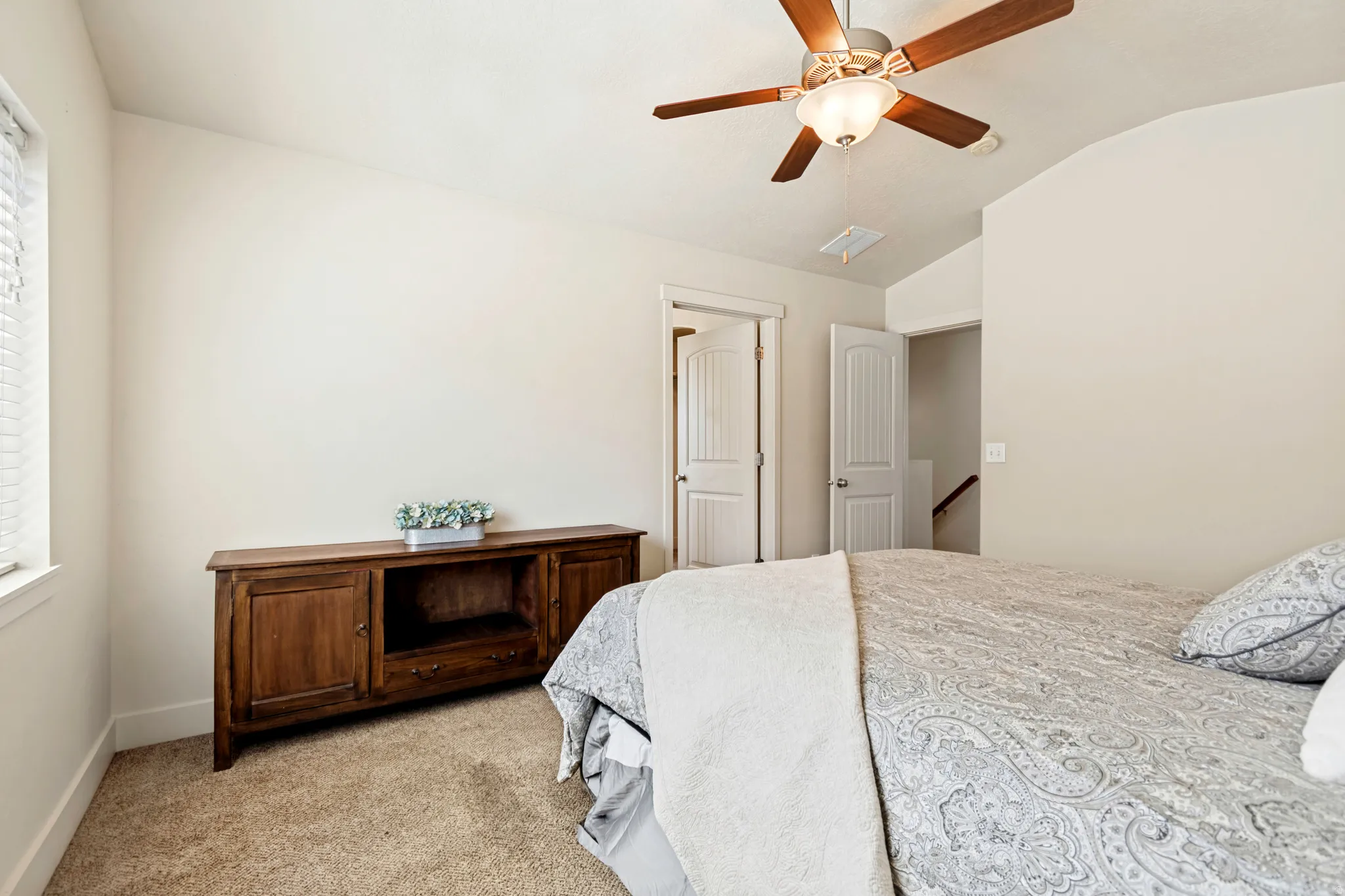 Room featuring light beige walls and brown carpet flooring