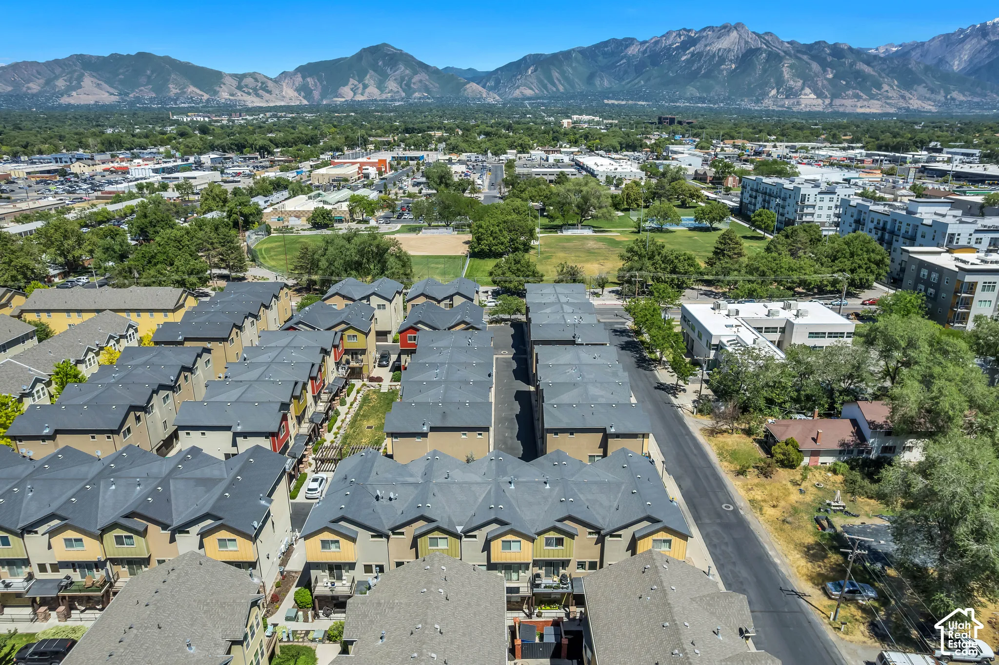 Townhome community featuring multi-story residences with private balconies and dark-toned roofing