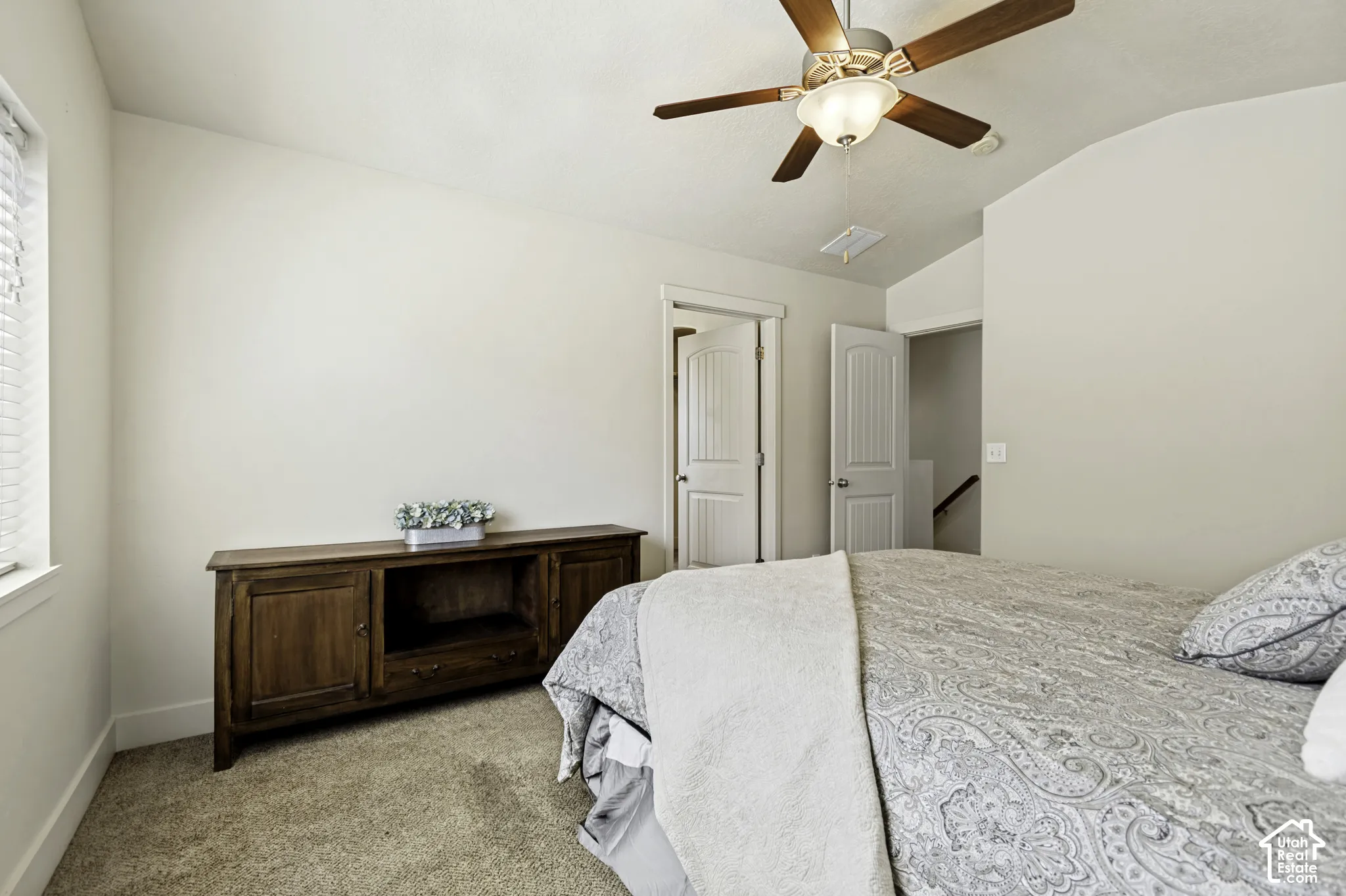 Room featuring light beige walls and brown carpet flooring