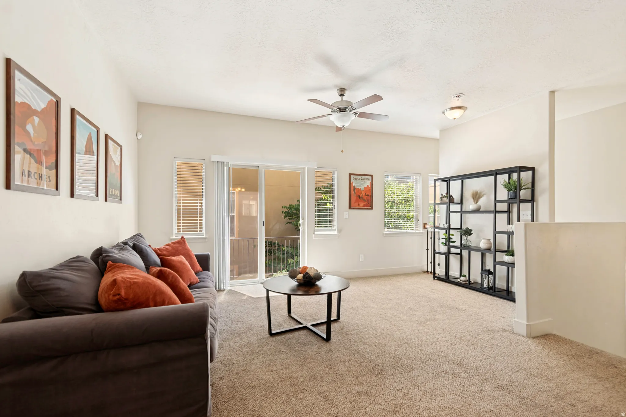 Spacious living area featuring neutral carpeting and light-toned walls