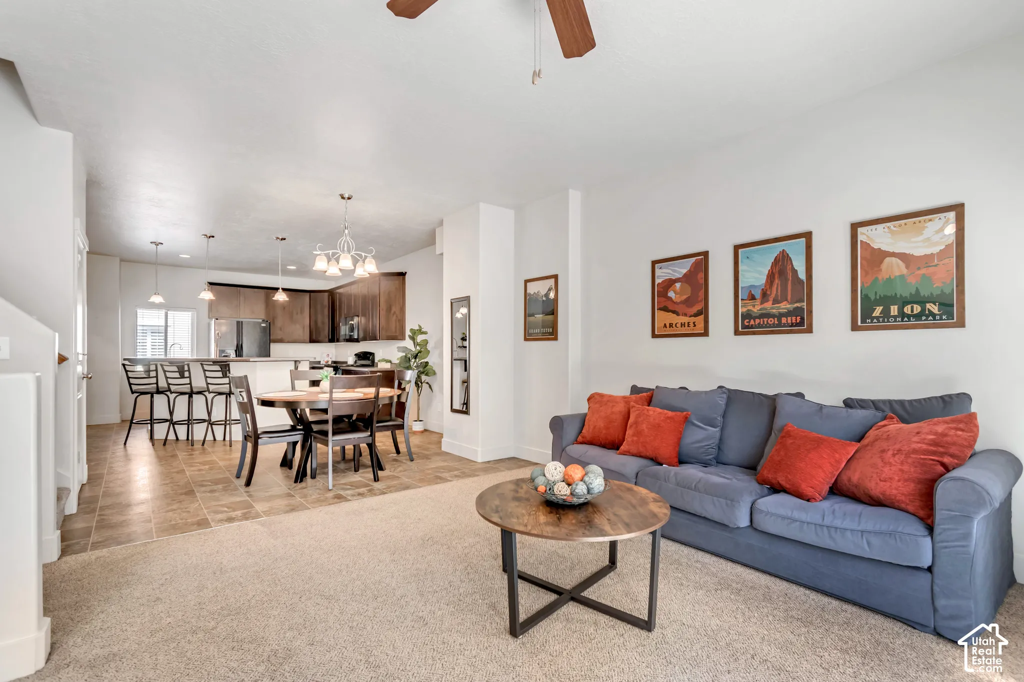 Open concept living area featuring light-toned carpeting and neutral wall finishes