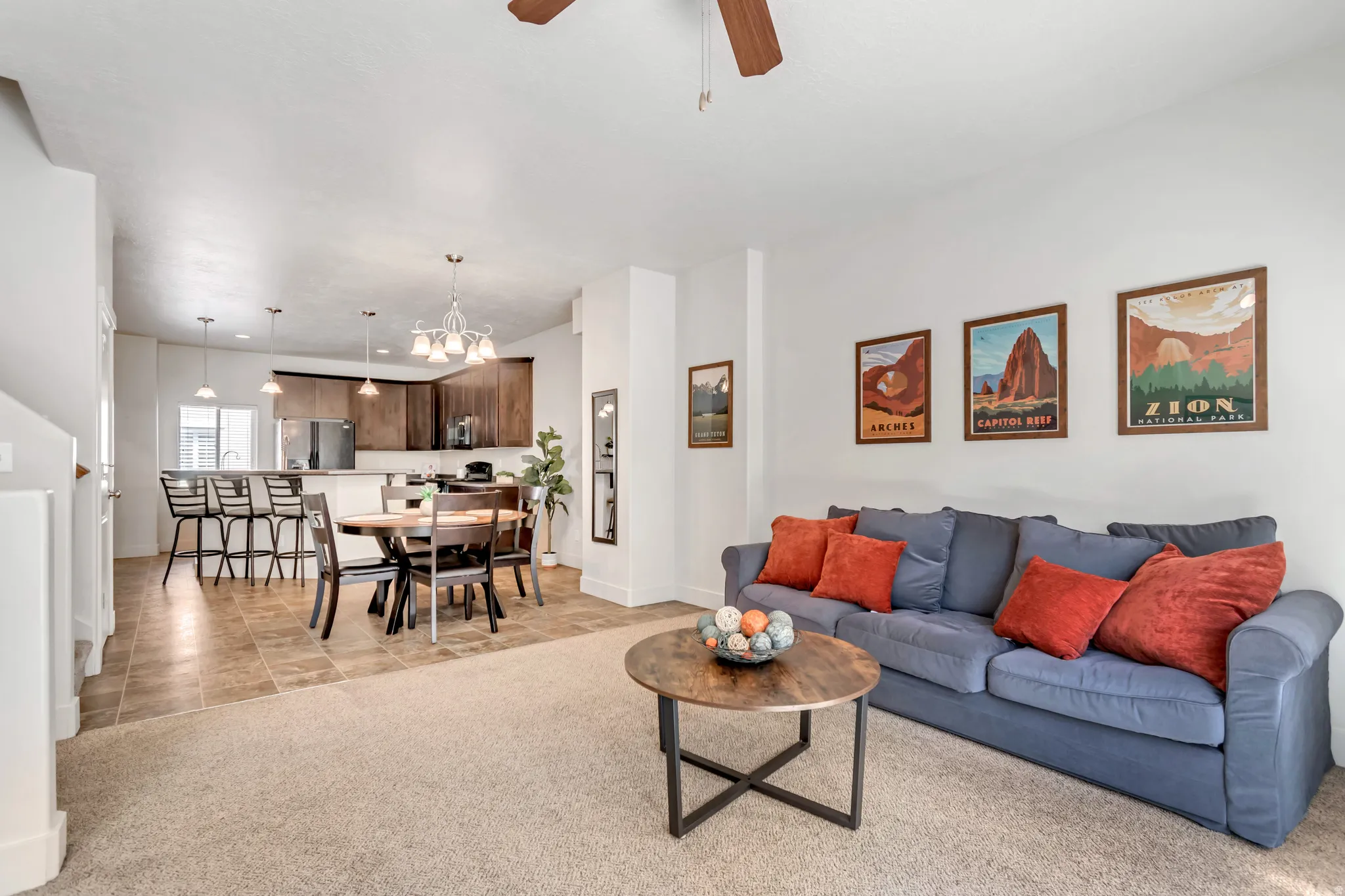 Open concept living area featuring light-toned carpeting and neutral wall finishes