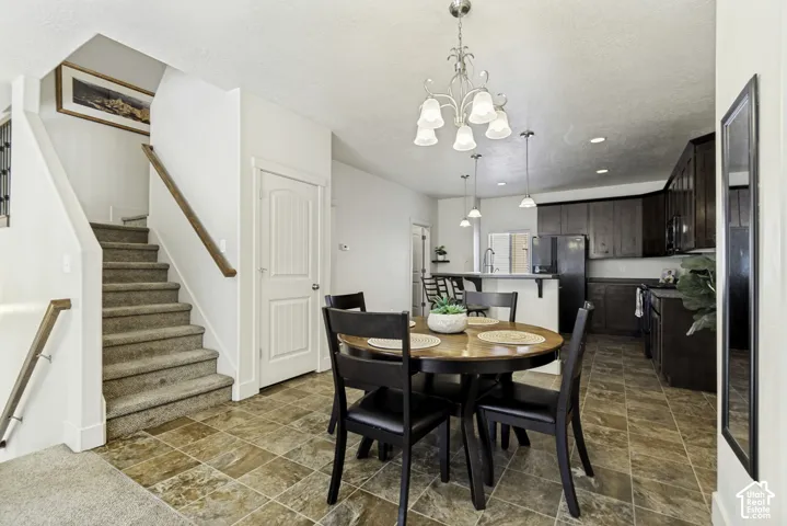 Open-concept dining and kitchen area featuring a prominent staircase