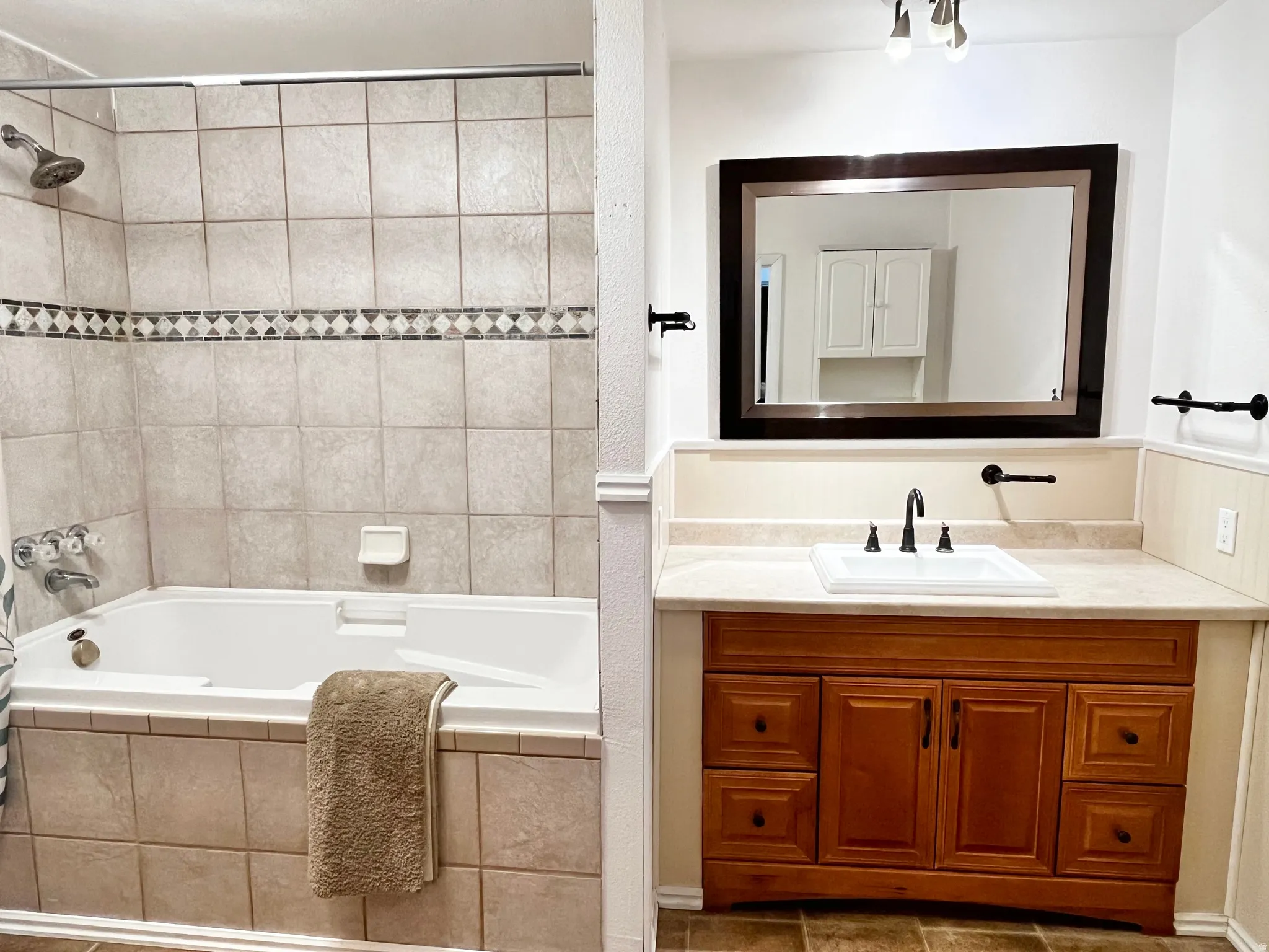 Bathroom featuring a tiled shower and soaking tub combination