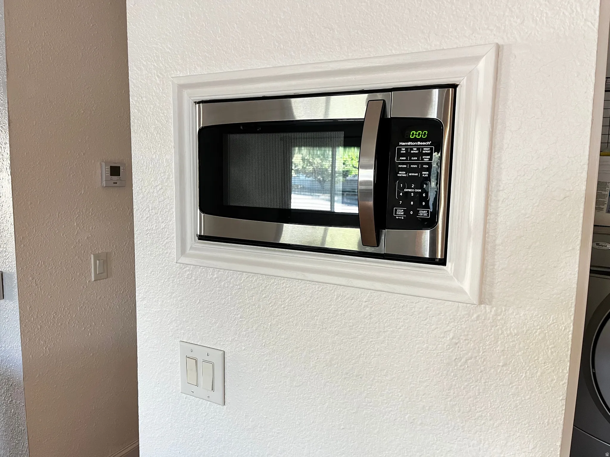 Built-in stainless steel microwave with a modern trim kit