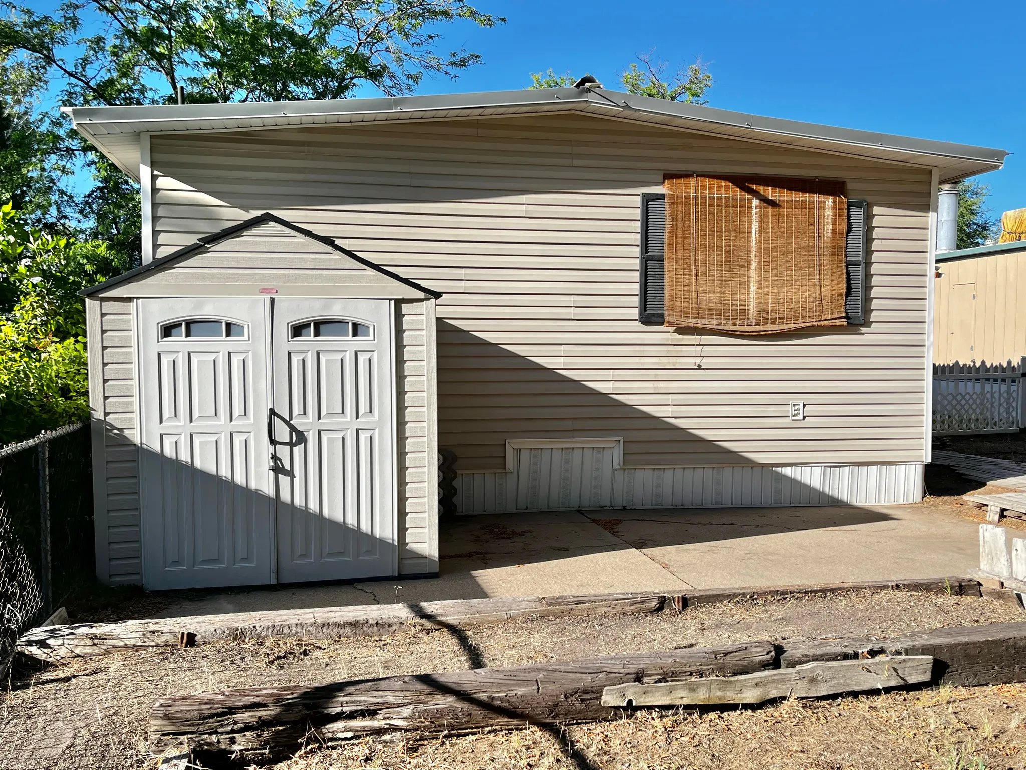 Exterior featuring horizontal siding, white trim, and a concrete patio
