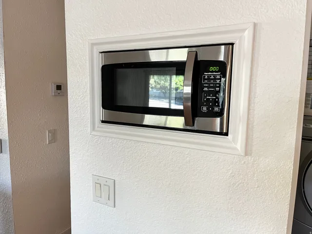 Built-in stainless steel microwave with a modern trim kit