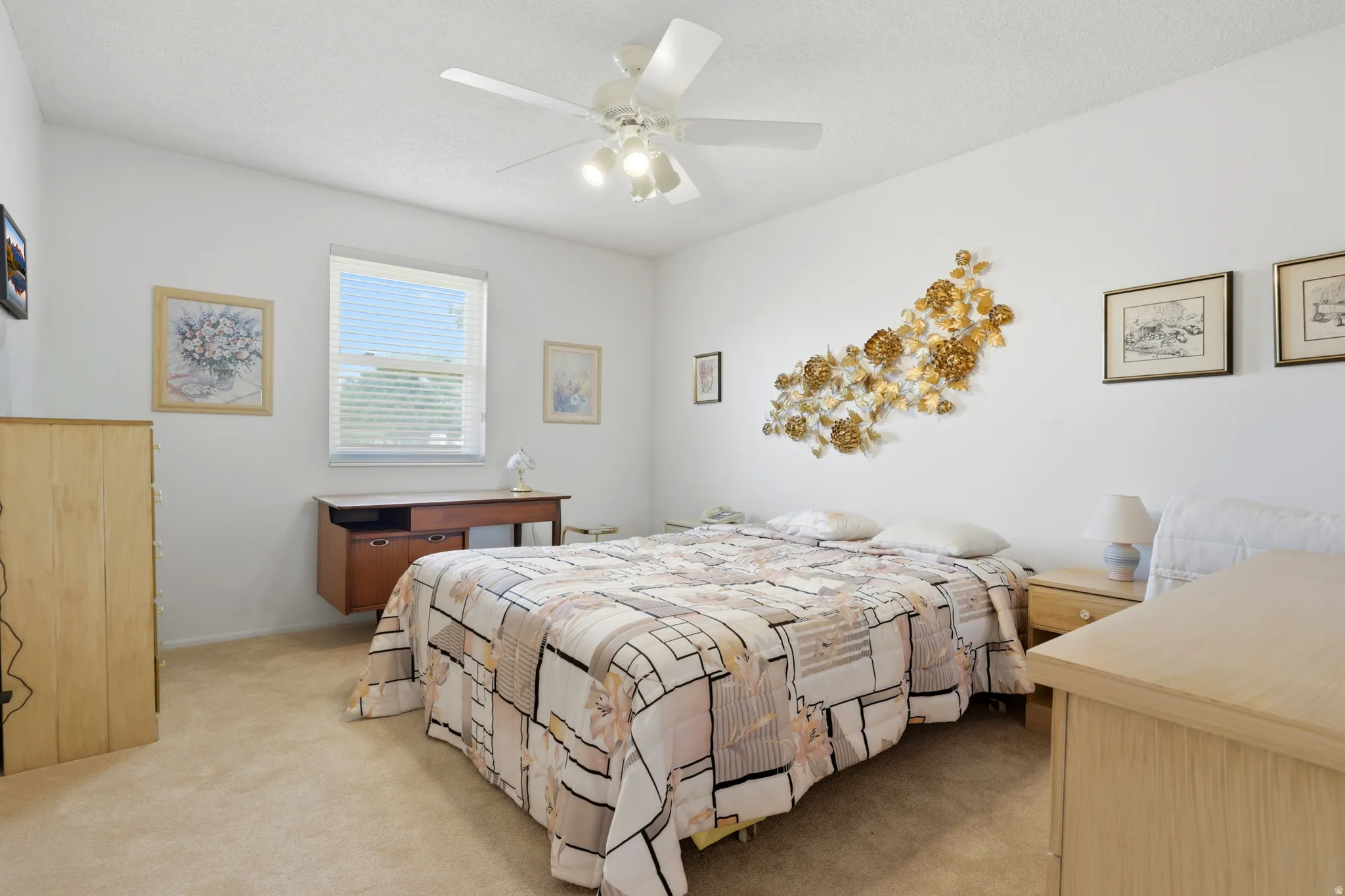 Bedroom featuring light beige carpeting, a ceiling fan with integrated lighting, and a single window with horizontal blinds