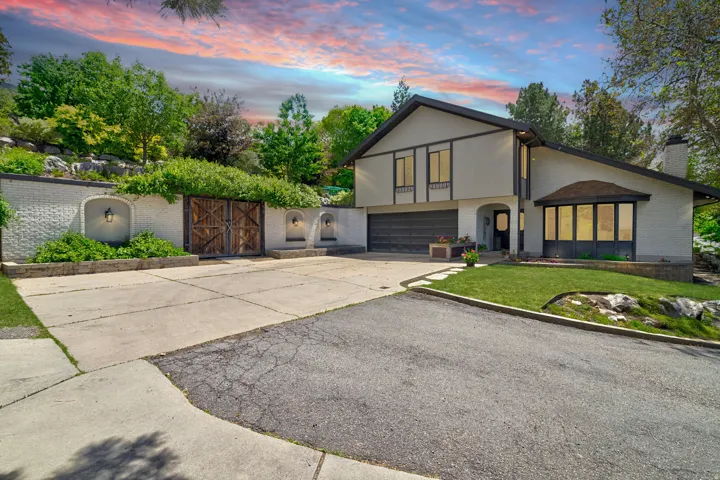 Contemporary two-story residence featuring a light-toned exterior with dark trim accents