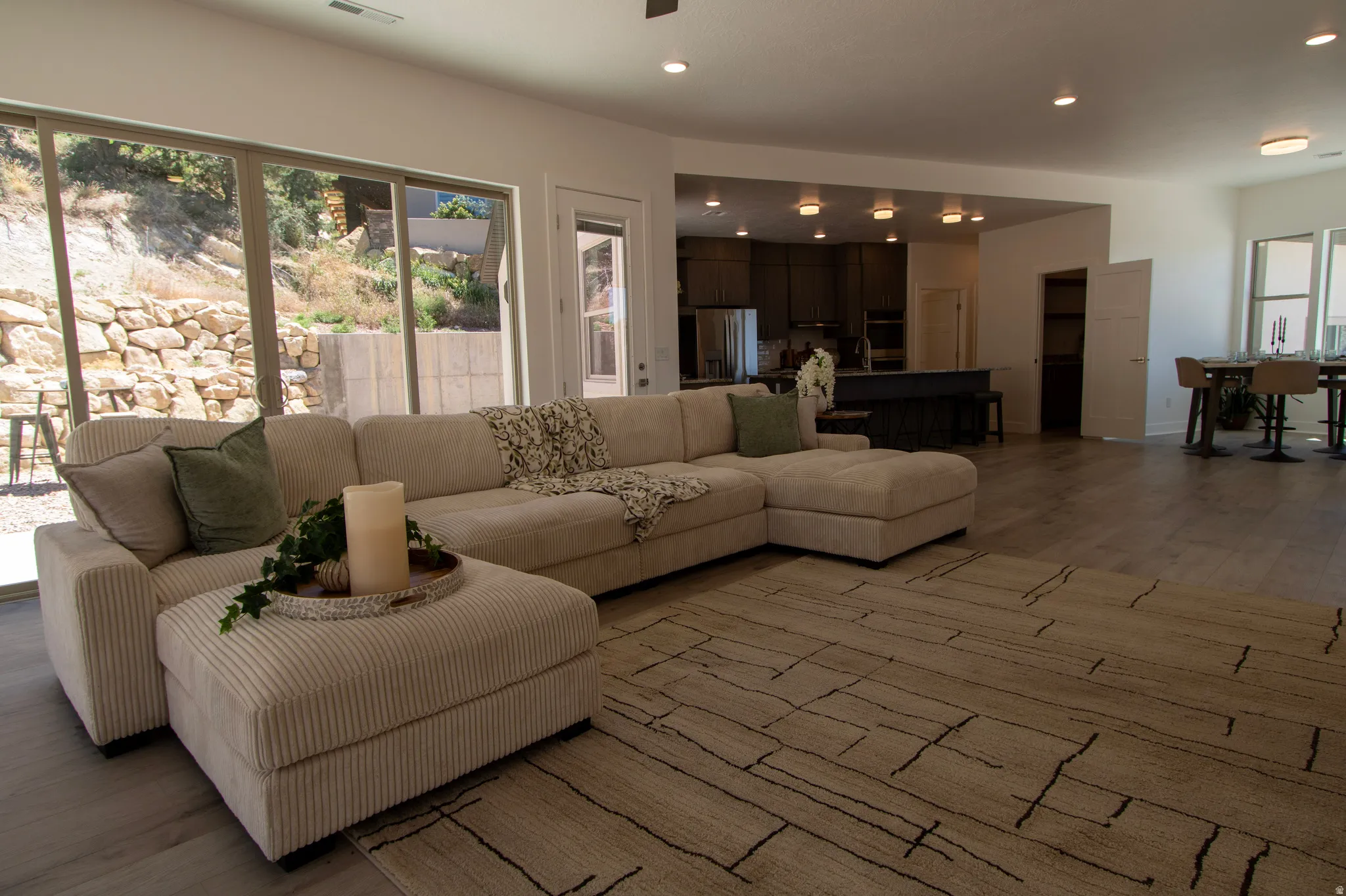 Open-concept living space featuring wood-finish flooring and ample natural light from large sliding glass doors