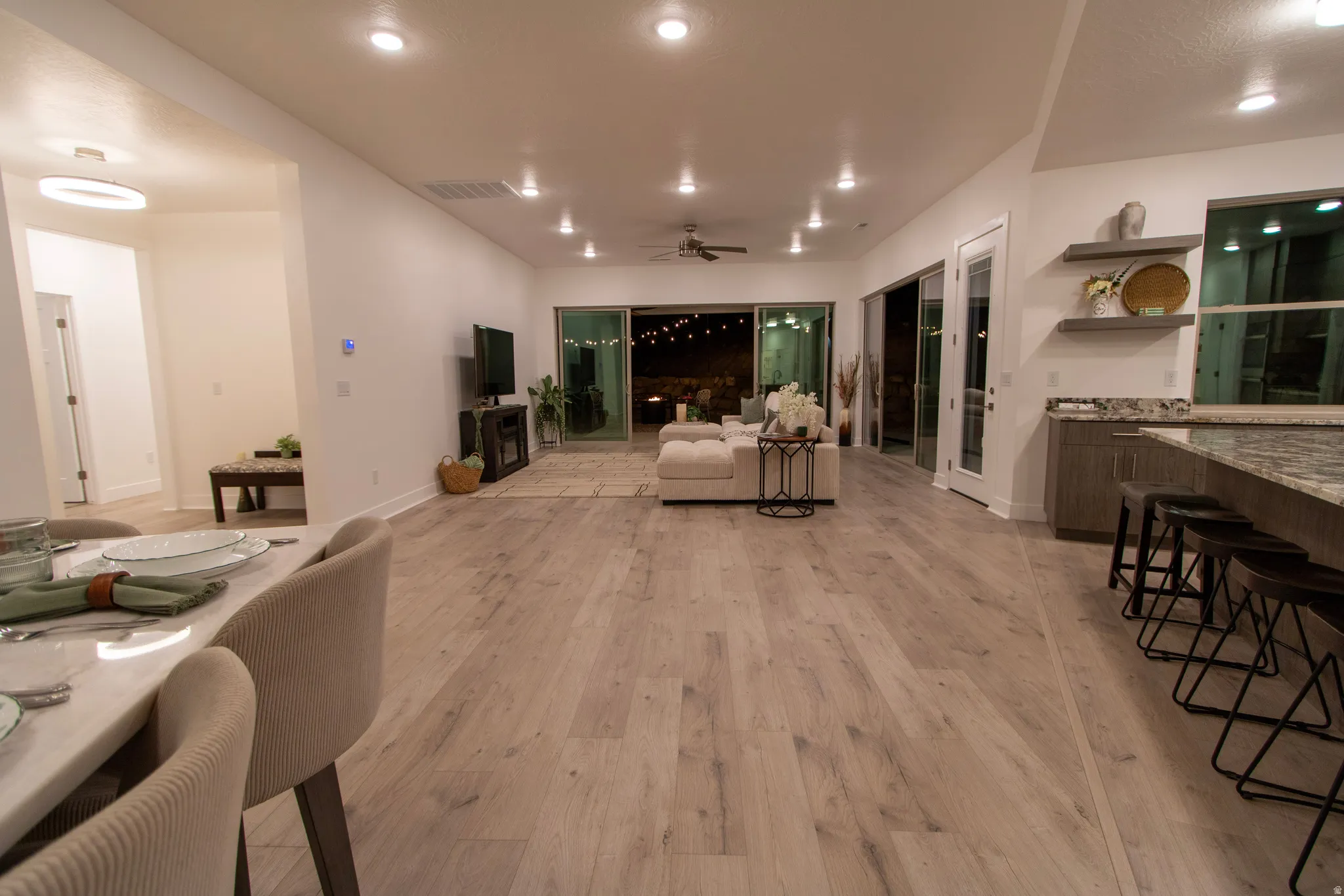 Spacious interior featuring wood-finish flooring, recessed lighting, and a contemporary ceiling fan