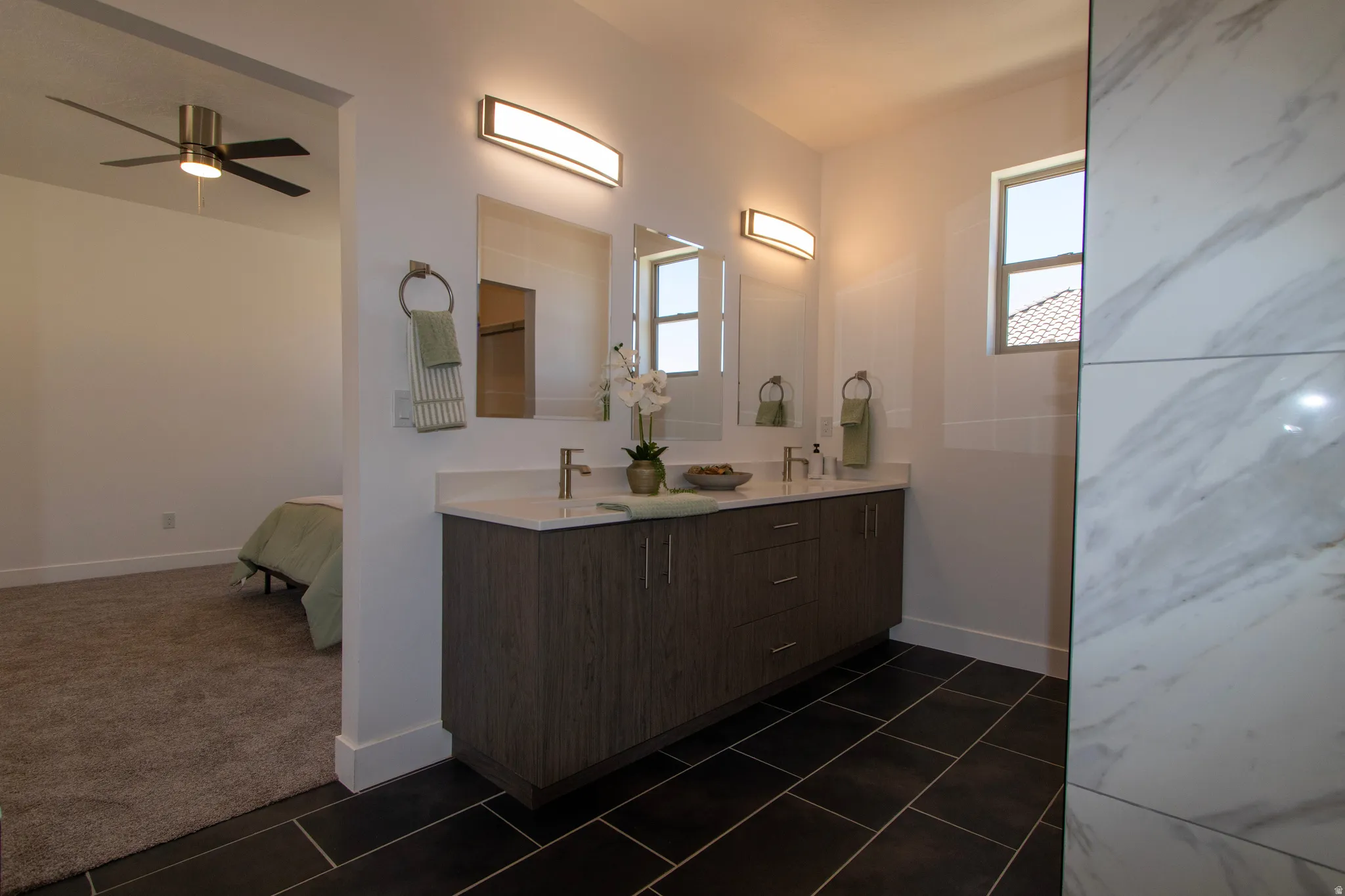 Bathroom vanity featuring dual rectangular undermount sinks, chrome faucets, and a white countertop