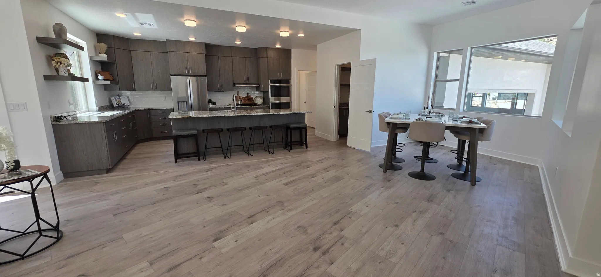 Open-concept living space with light wood-finish flooring
