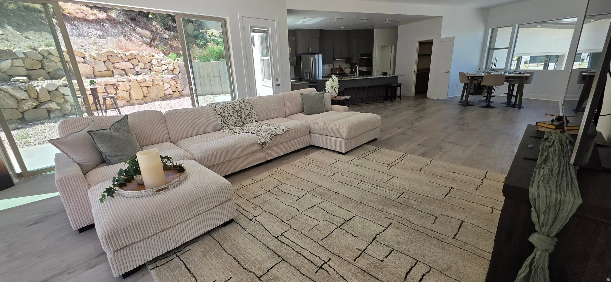 Open-concept living space featuring wood-finish flooring and large sliding glass doors