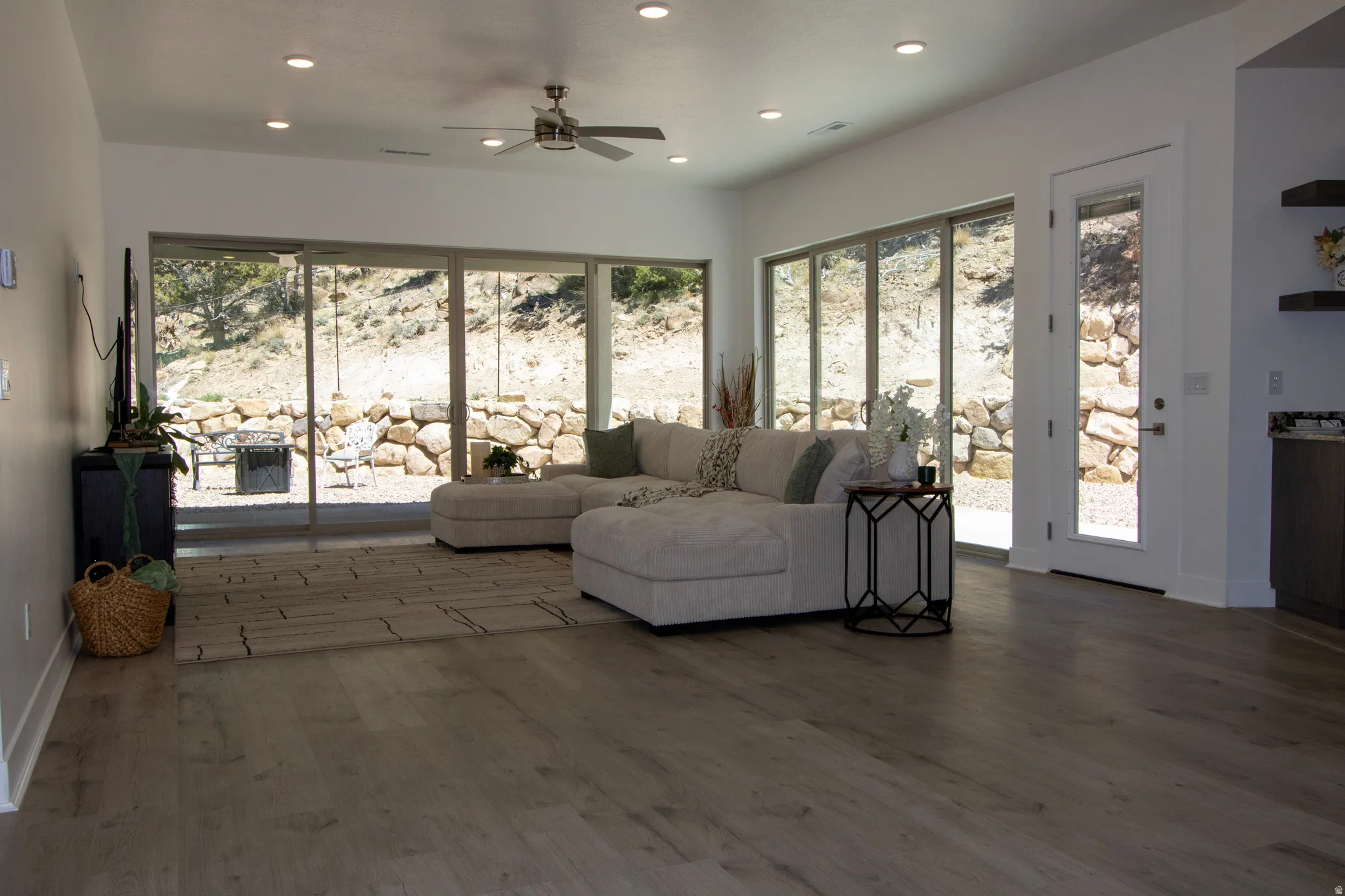 Spacious interior featuring wood-finish flooring, recessed lighting, and a ceiling fan