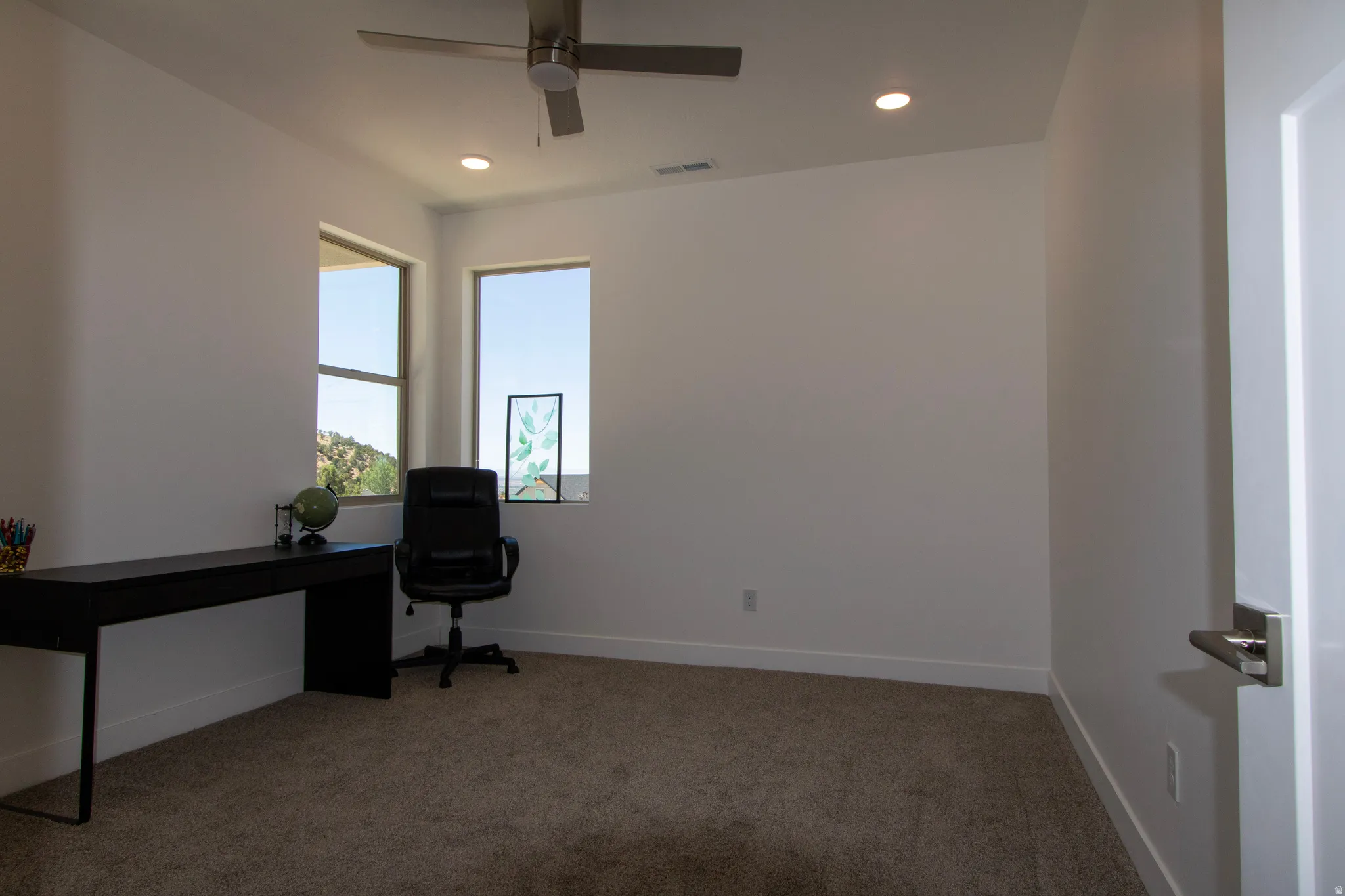 Room with neutral carpeting and white walls