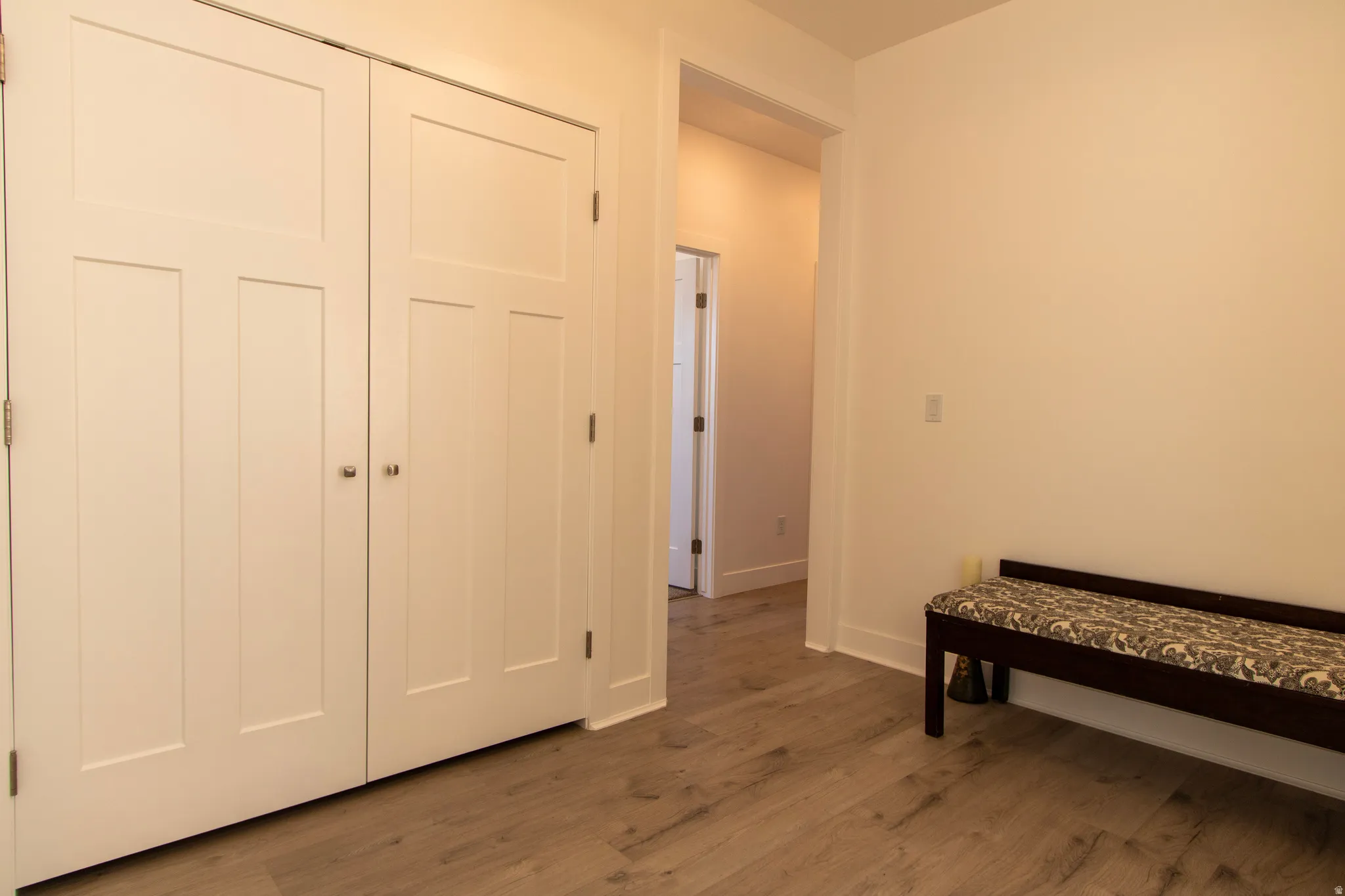 Light wood-finish flooring complements white walls and trim