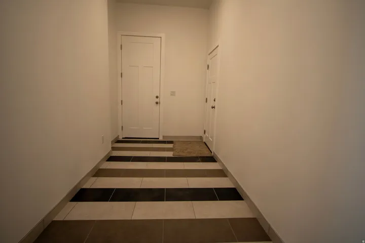 Entryway with striped tile flooring and a neutral color palette