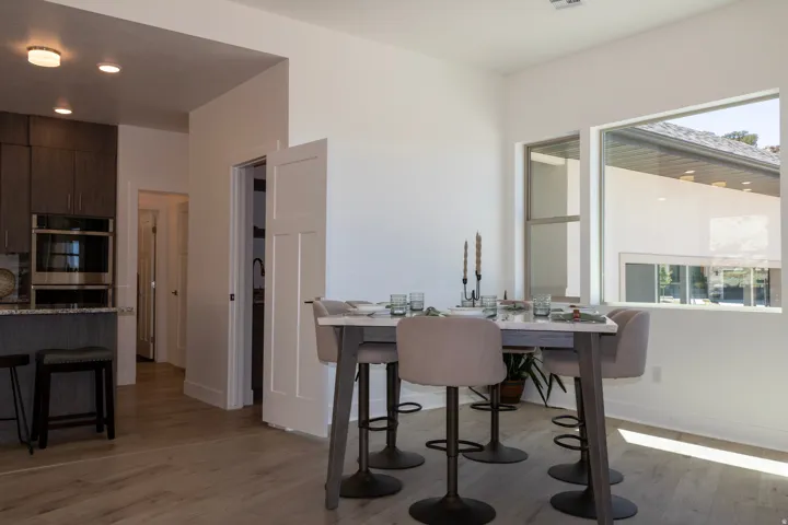 Open-concept dining area featuring light wood-finish flooring, a contemporary window design, and recessed lighting