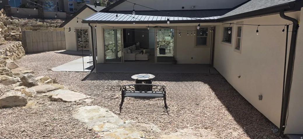 Expansive gravel hardscape surrounding a concrete patio