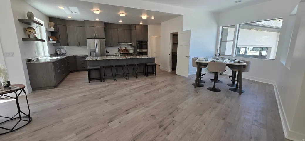 Open-concept living space with light wood-finish flooring