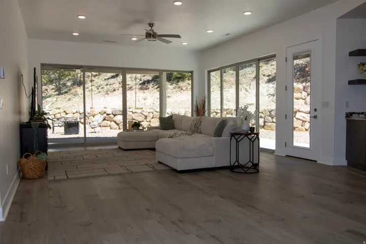 Spacious interior featuring wood-finish flooring, recessed lighting, and a ceiling fan