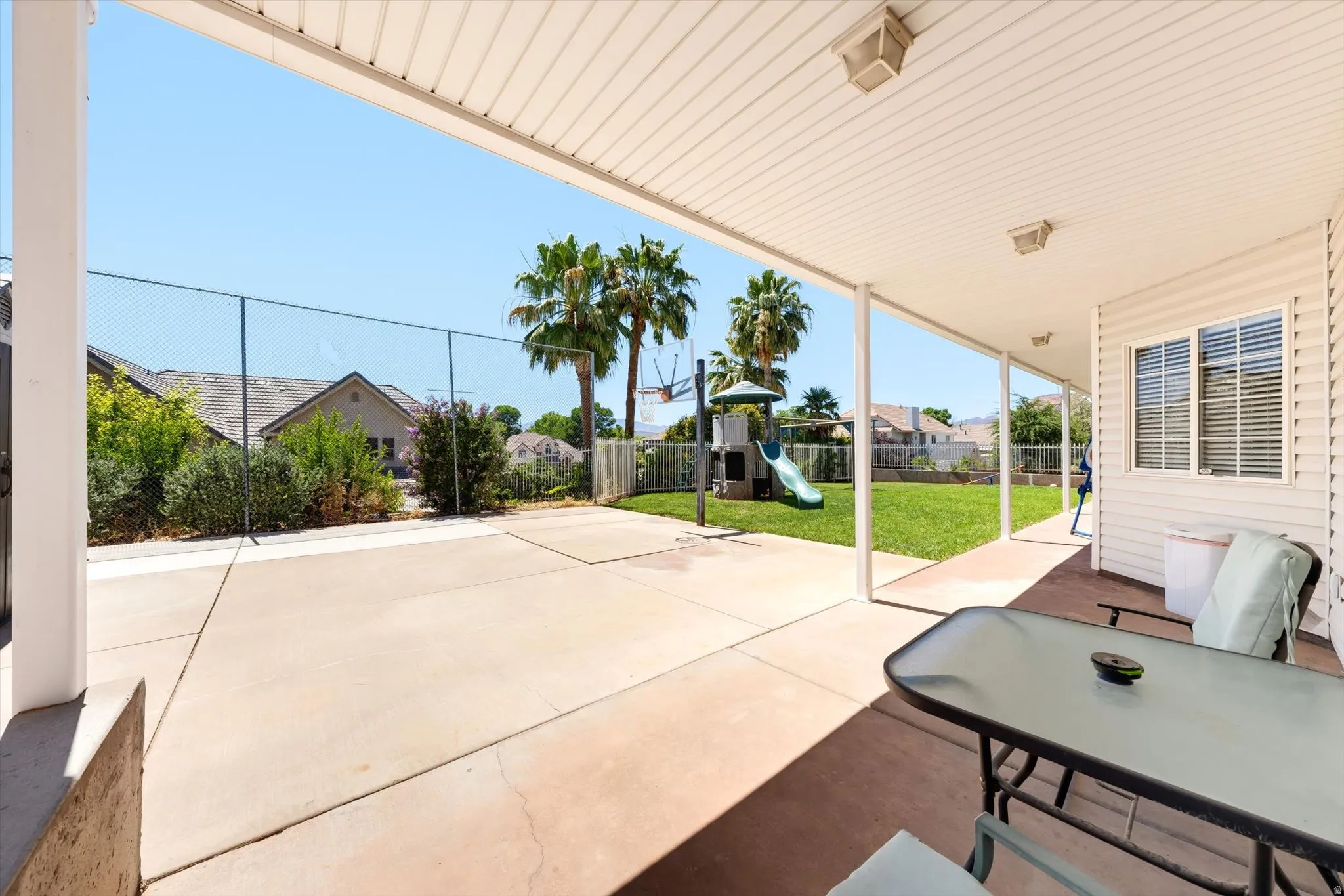Expansive covered patio with recessed lighting and concrete flooring