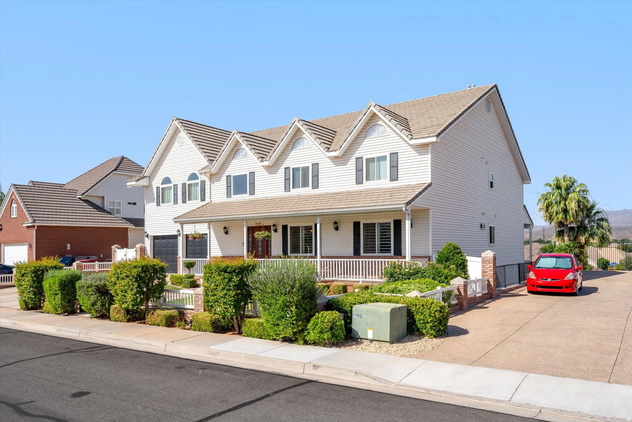 Two-story property featuring white siding and a covered front porch with white railing