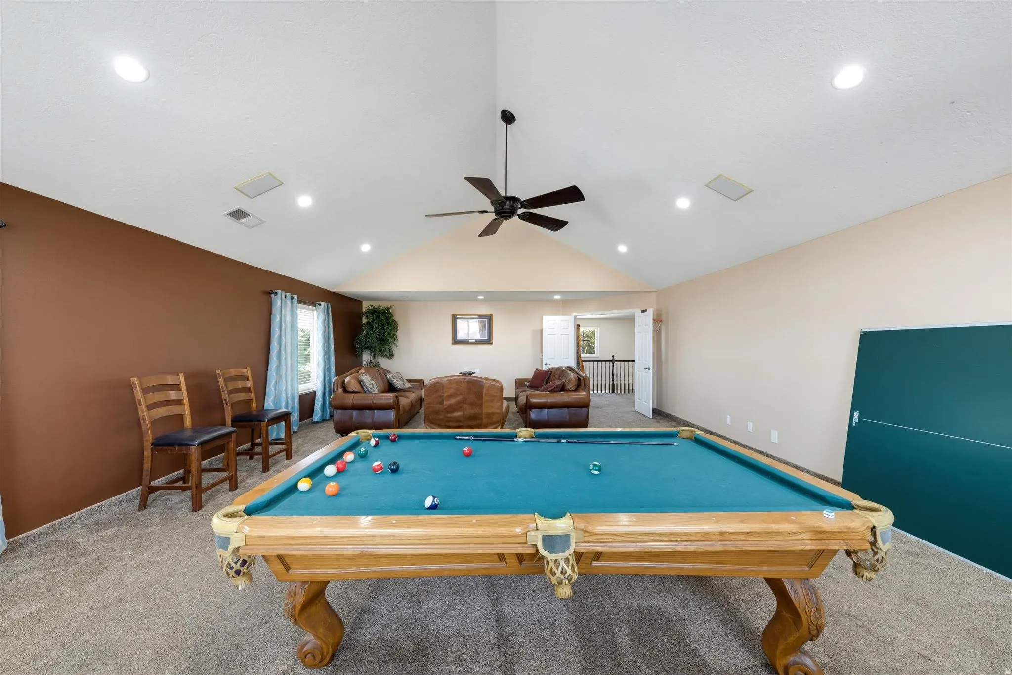 Spacious bonus room featuring vaulted ceilings, recessed lighting, and a ceiling fan