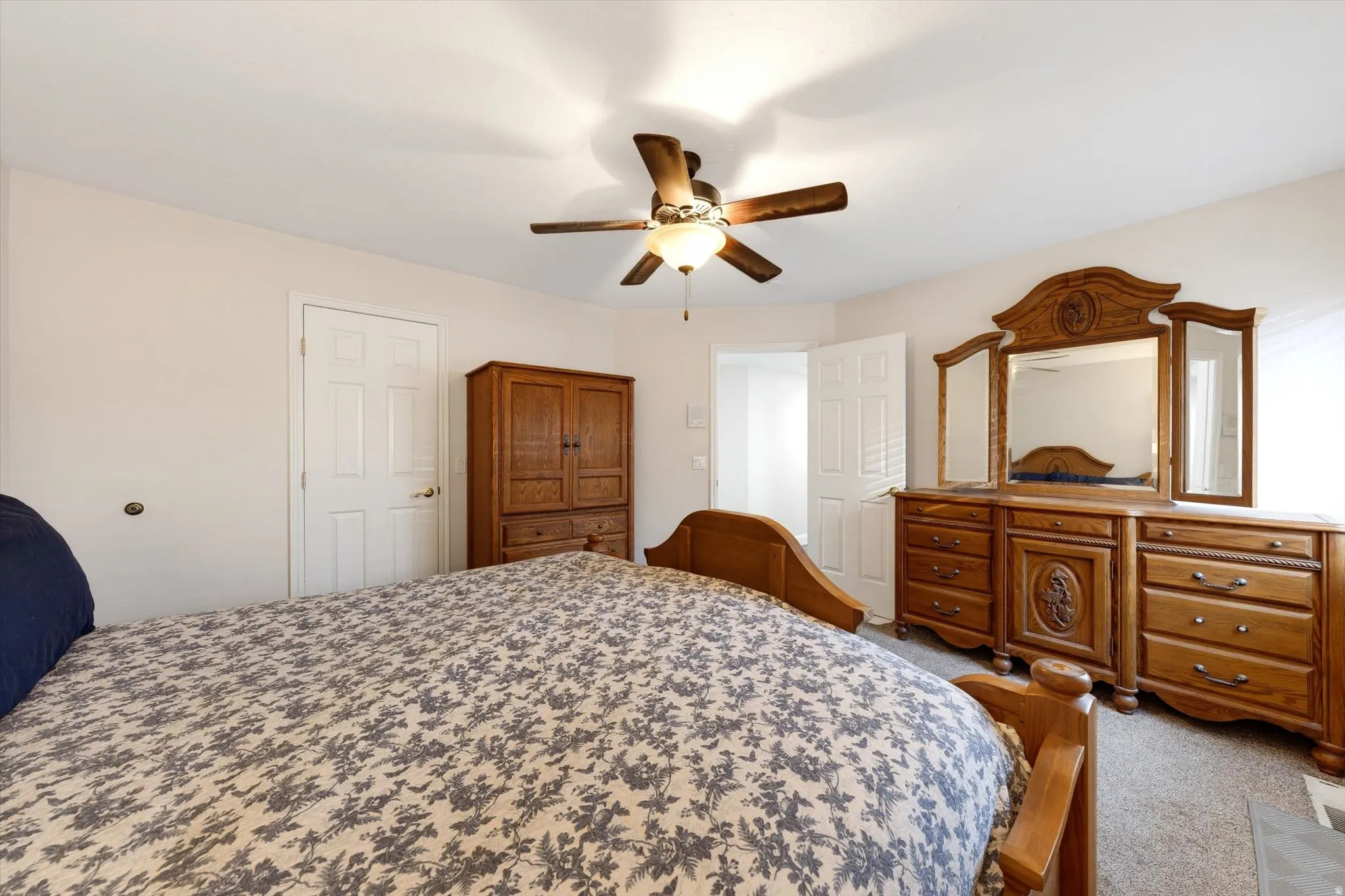 Neutral wall tones in a room featuring a ceiling fan with integrated lighting