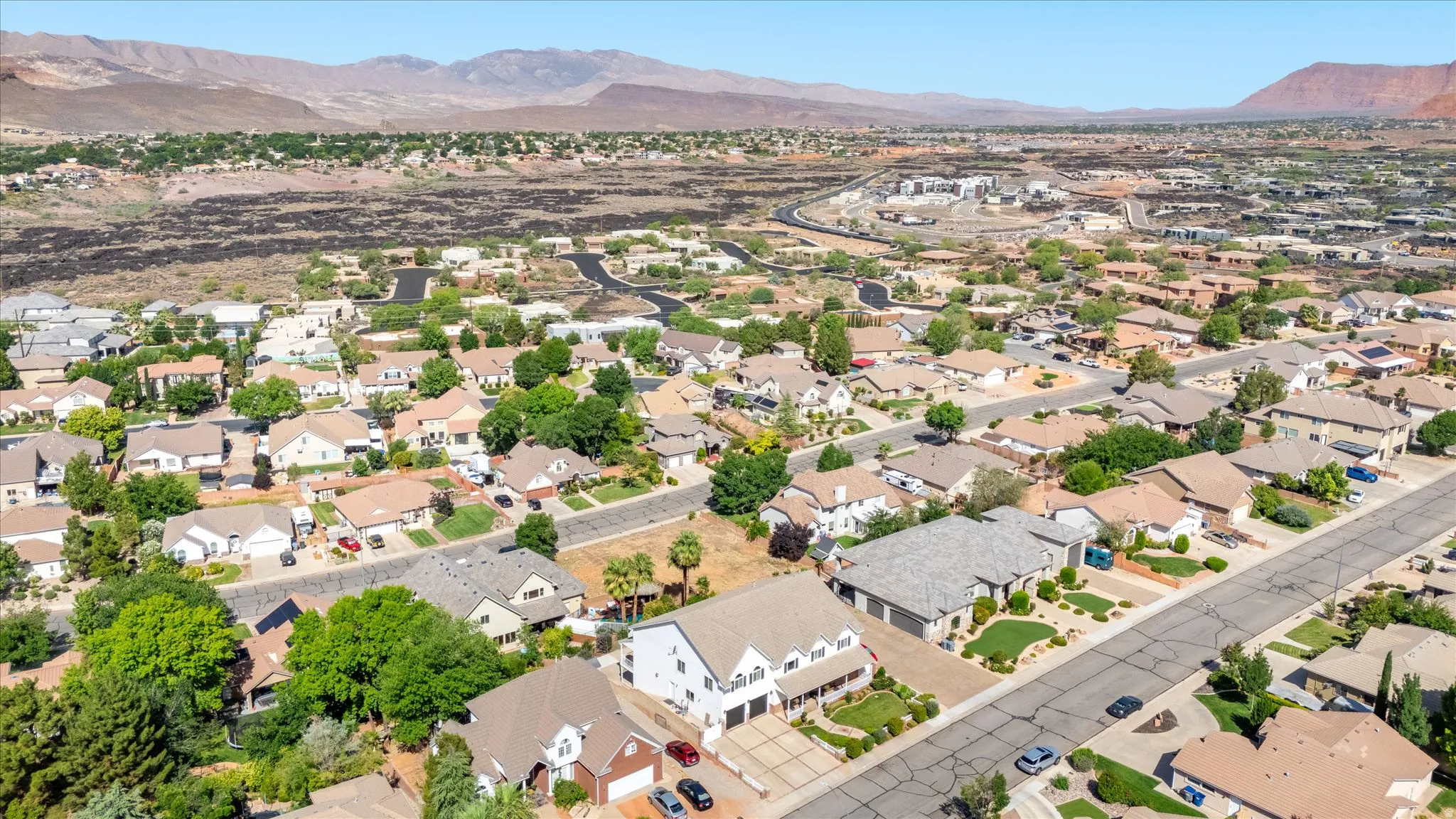 Residential neighborhood featuring a variety of single-family homes, mature landscaping, and paved streets