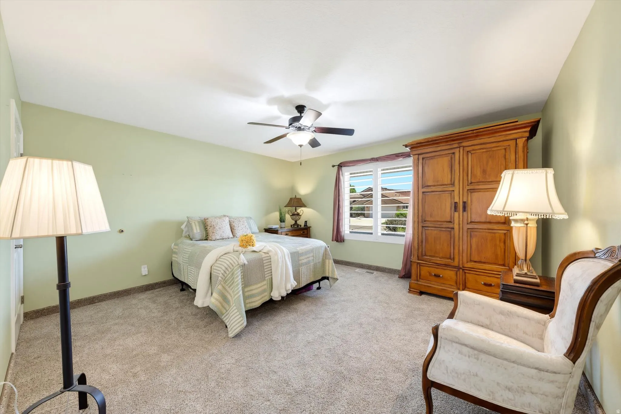 Carpeted room with light green walls and a vaulted ceiling