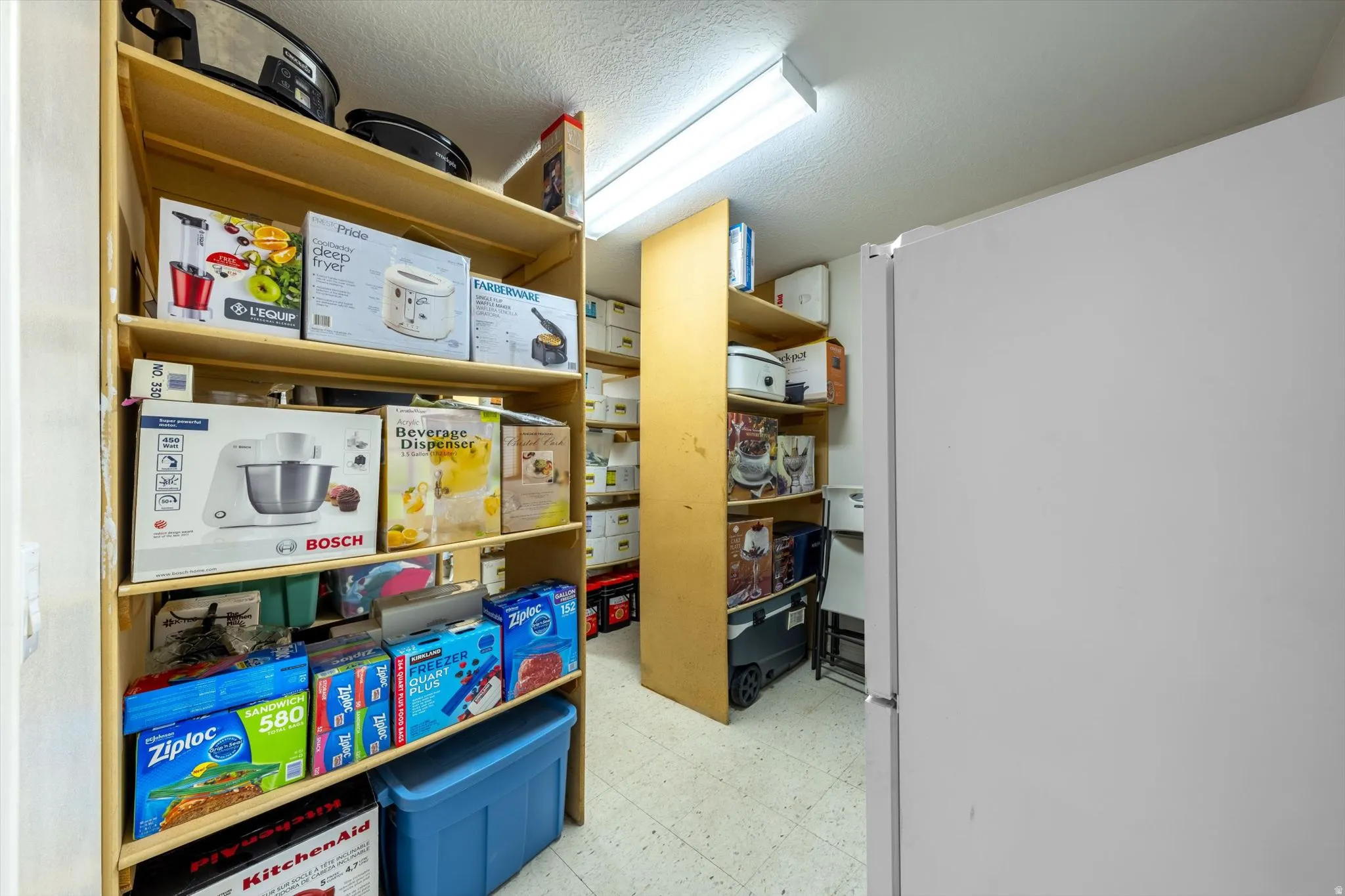 Floor-to-ceiling shelving within a dedicated storage area, featuring durable wood-finish construction and ample vertical space