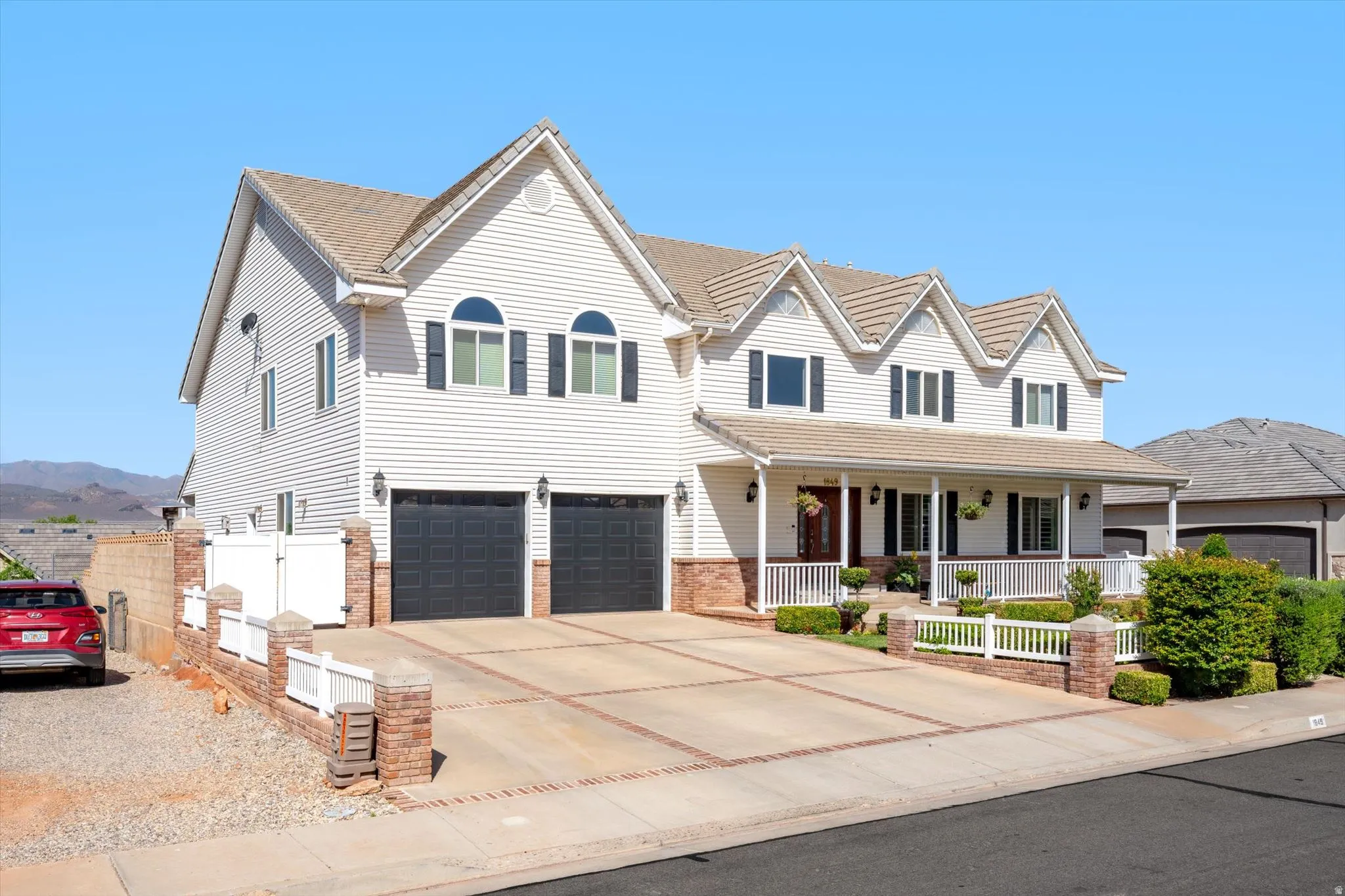 Traditional-style home featuring white siding and a covered front porch with white railings