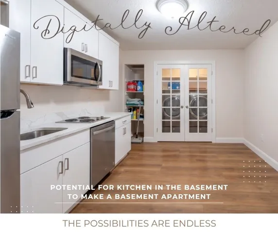 White flat-panel cabinetry, stainless steel appliances, quartz-finish countertops, wood-finish flooring, and double French doors with glass panels