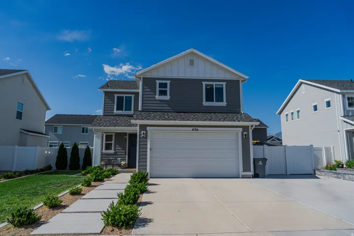 Modern two-story residence featuring gray siding and white trim accents