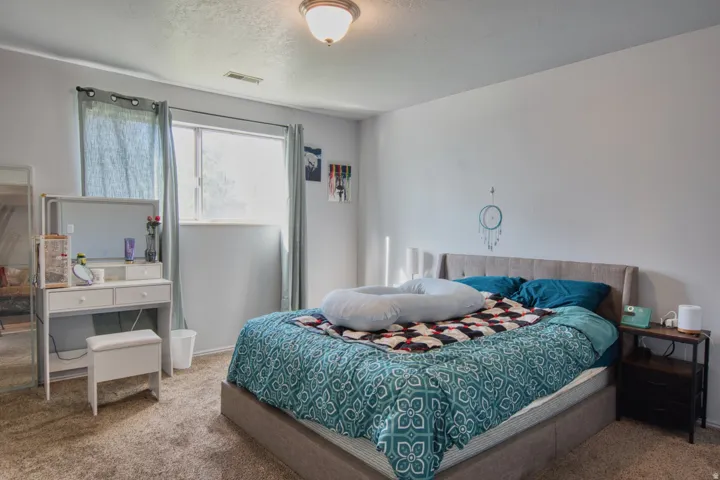 Carpeted room featuring a single window with curtains, recessed lighting, and a ceiling light fixture