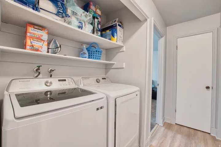 Dedicated laundry area featuring a white washing machine and dryer set