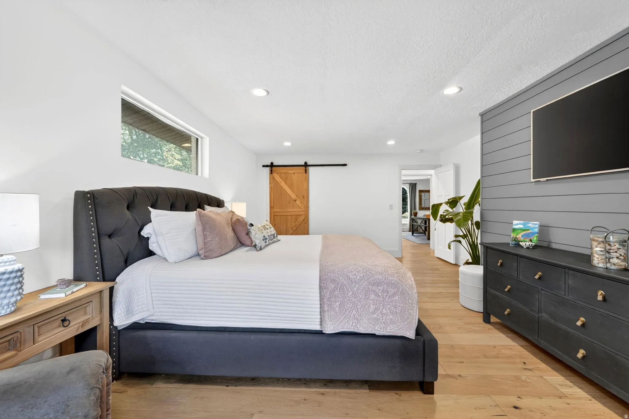 Bright interior featuring wood-finish flooring, recessed lighting, and a horizontal window