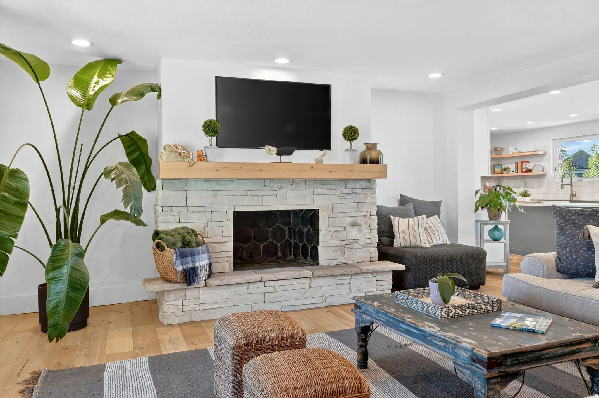 Living area with wood-finish flooring and recessed lighting
