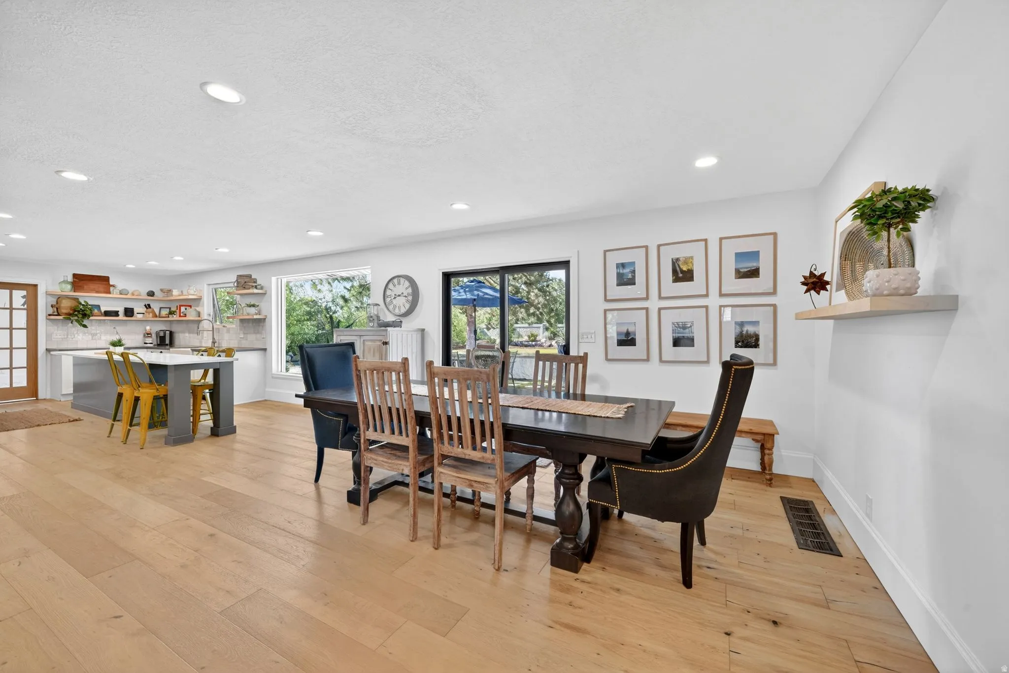Bright interior featuring wood-finish flooring, recessed lighting, and a kitchen with an island