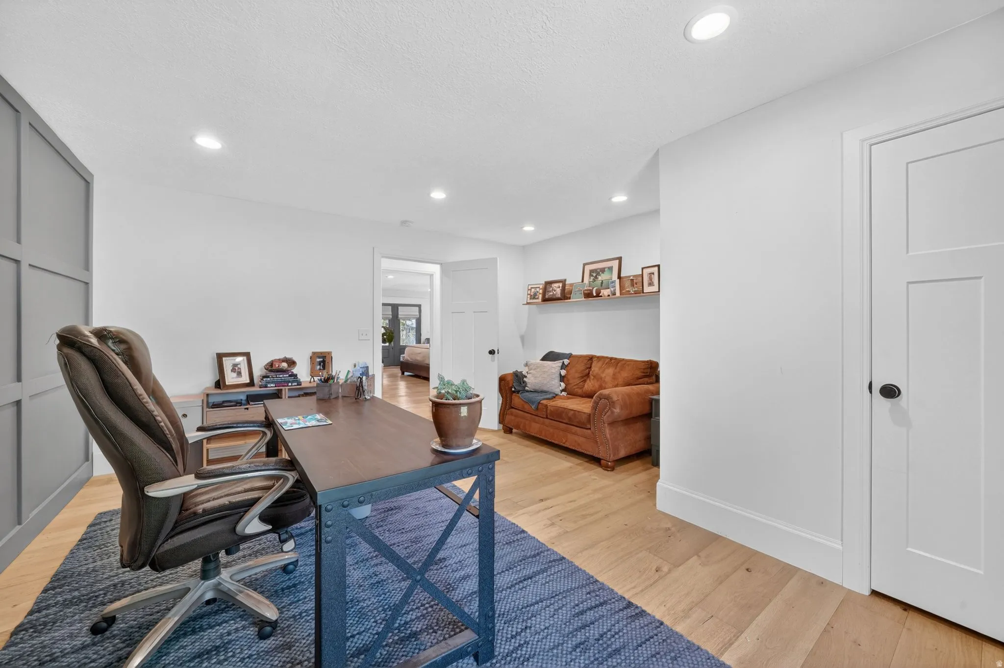 Dedicated office space featuring wood-finish flooring and recessed lighting