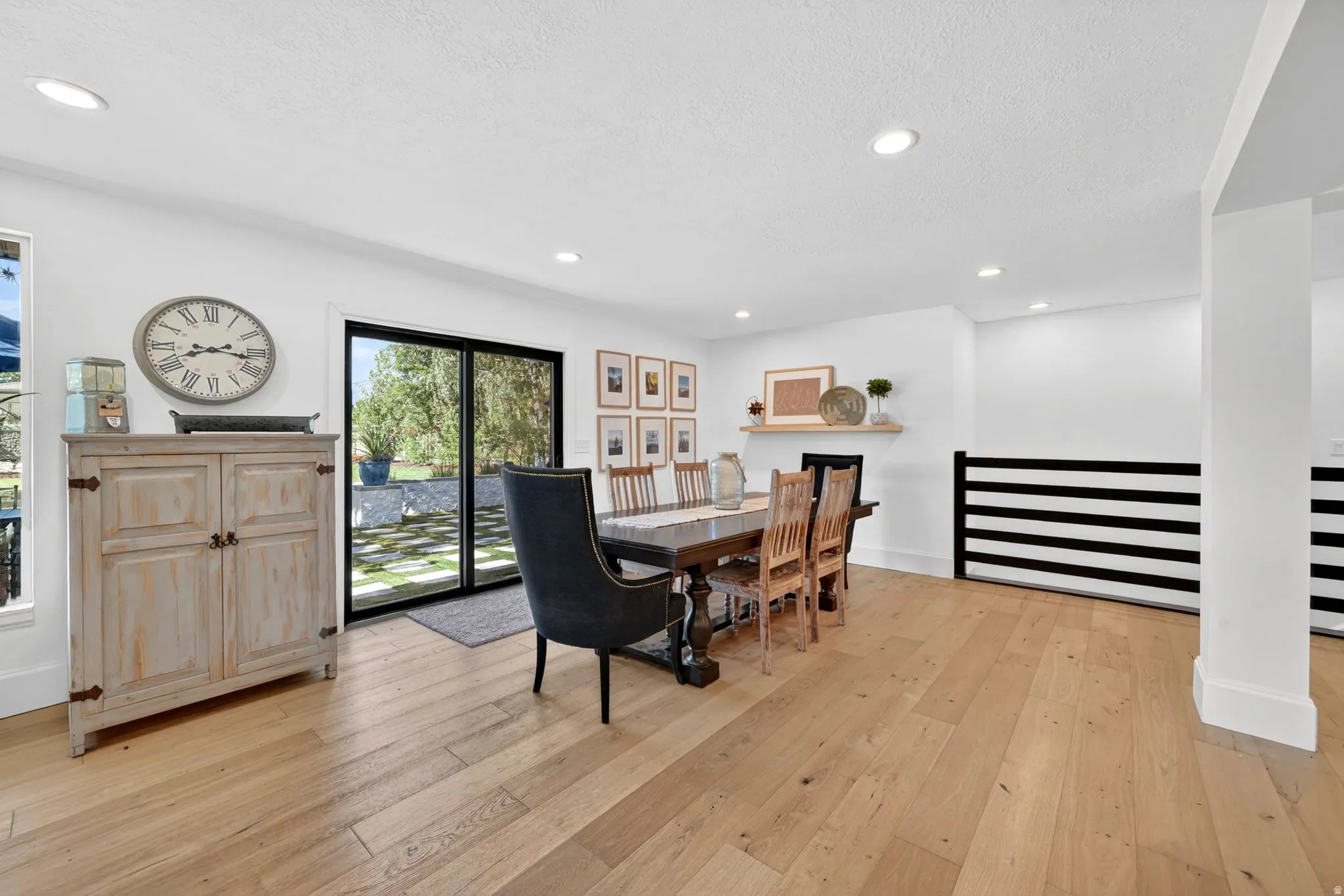 Spacious interior featuring wide-plank wood-finish flooring, recessed lighting, and white painted walls