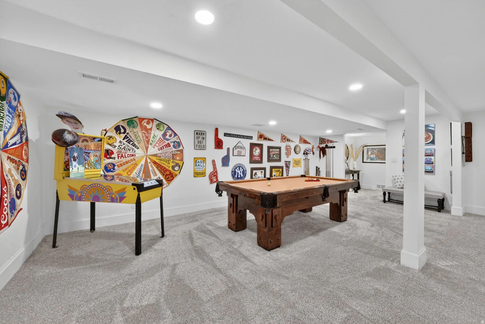 Spacious recreation area featuring a built-in pillar, recessed lighting, light gray carpeting, and white baseboards