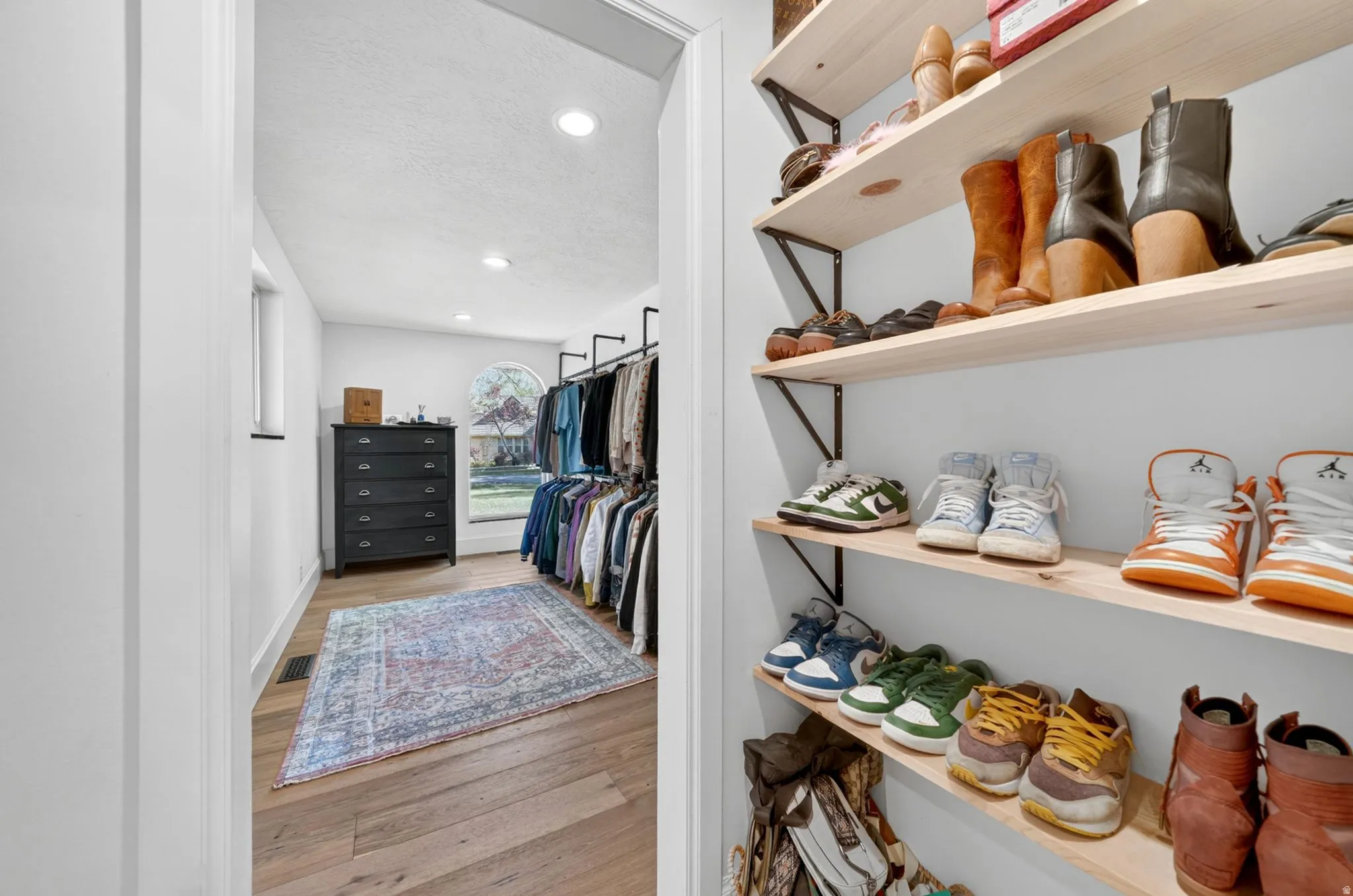 Custom closet system featuring built-in shelving and clothing racks