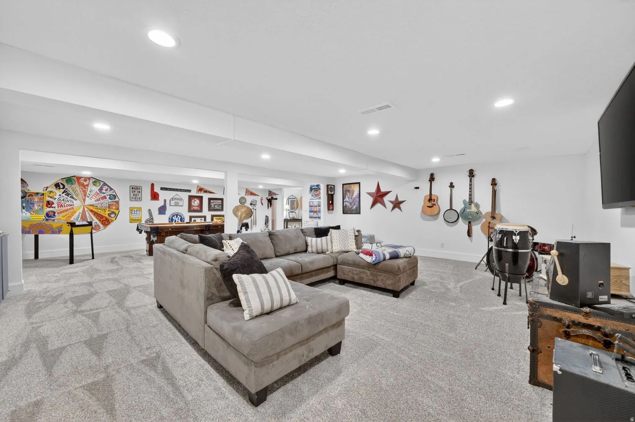 Spacious recreation room featuring recessed lighting, light-toned carpet, and an open layout with multiple zones